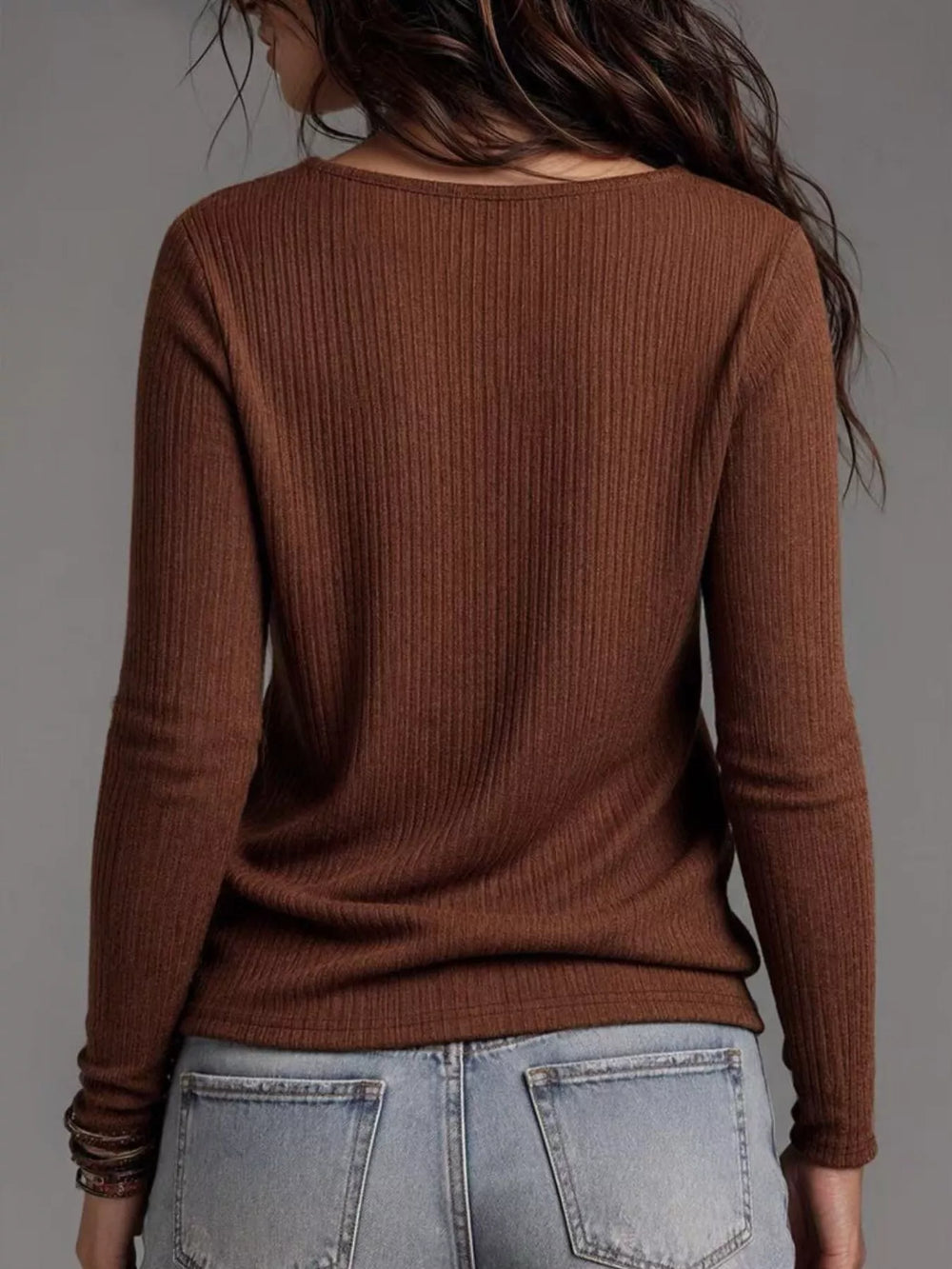 Back view of the dark brown ribbed long sleeve top with jeans