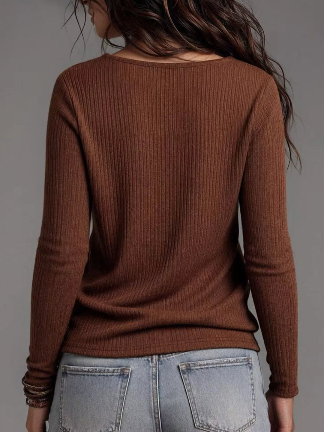 Back view of the dark brown ribbed long sleeve top with jeans