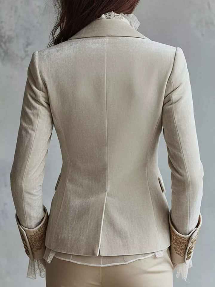 Back view of the cream fitted blazer with embroidered cuffs