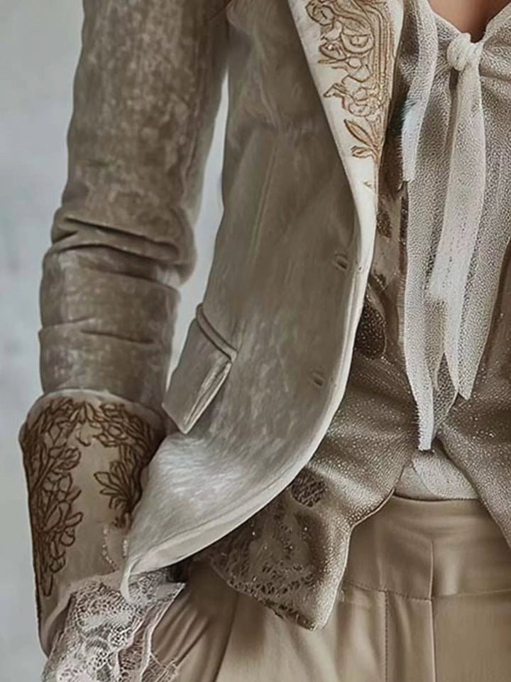 Close-up of the embroidered cuff with lace trim on the cream fitted blazer
