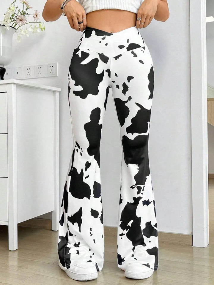 Cow print high waisted flare pants with V waistband, close front view