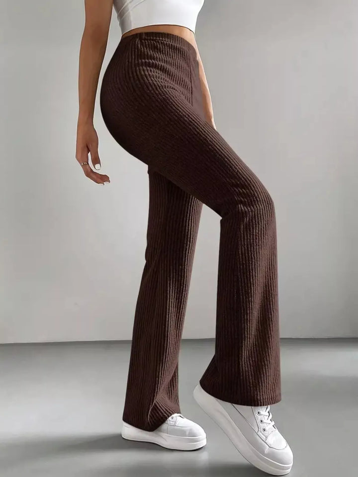 Chocolate brown stretch flare pants in a walking pose, full length