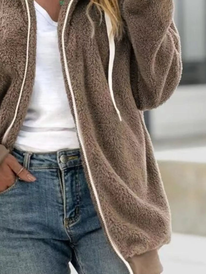 Mocha hooded fleece jacket with long sleeves, side view over jeans