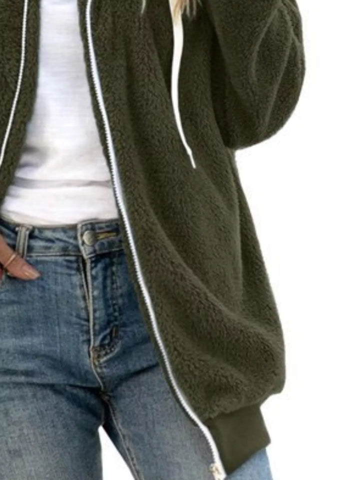 Olive green fleece jacket close-up of the zipper and ribbed hem