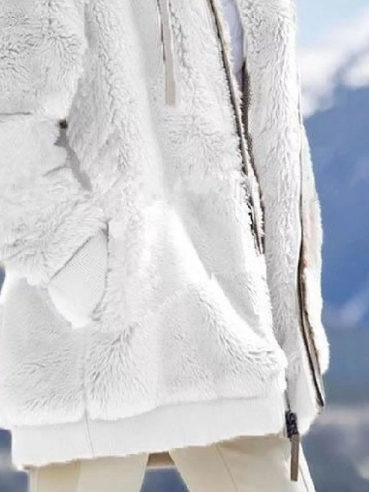 White fuzzy fleece jacket close-up of the zipper and front pocket