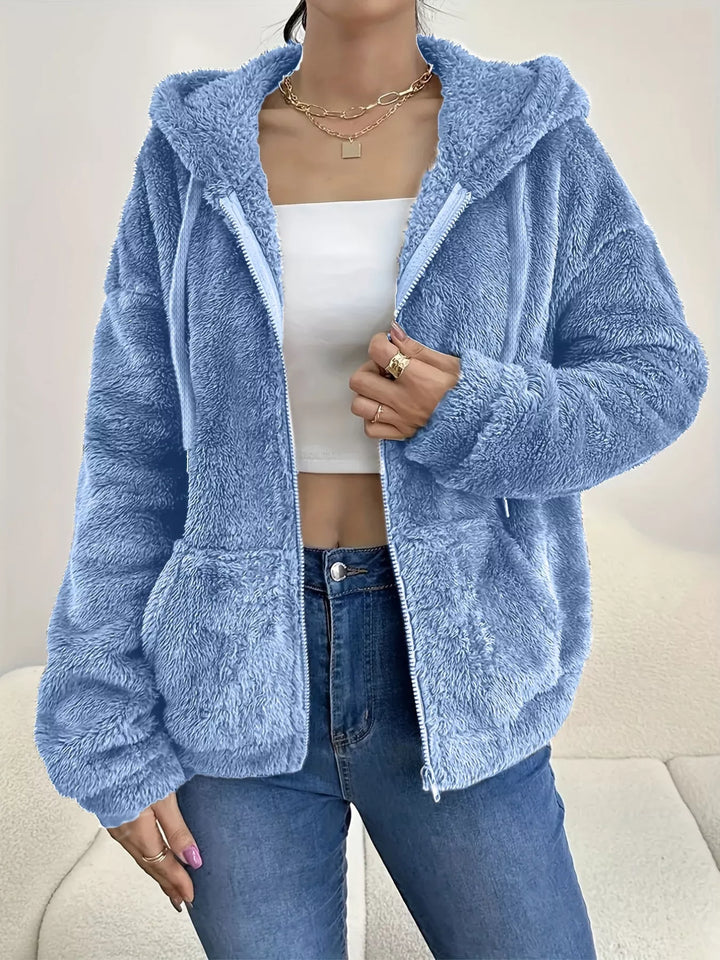 Women's fleece jacket in sky blue, hooded zip up with drawstring hood, worn with jeans