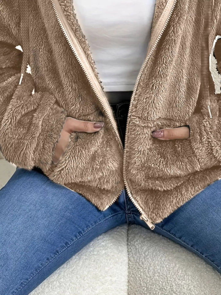 Close-up of taupe fleece jacket open zip front and hood drawstring