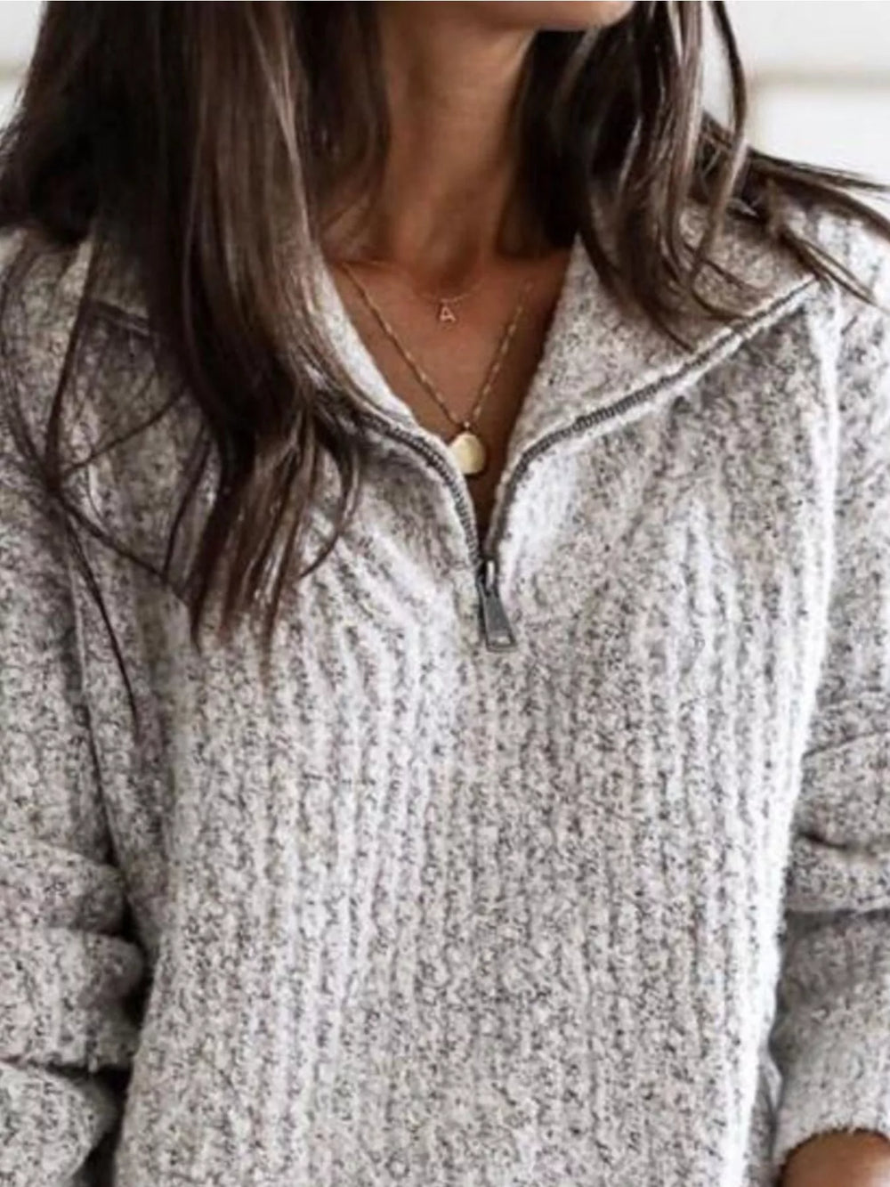 Light gray half zip sweater close-up of the zipper and ribbed collar