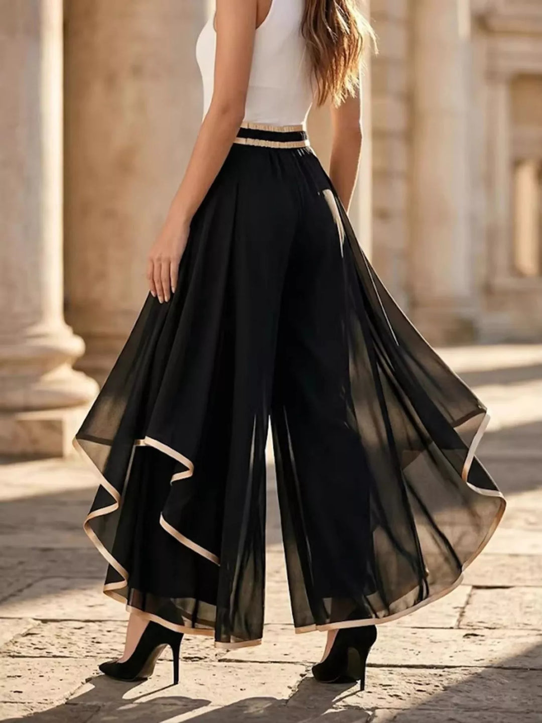 Back view of the black wide leg pants with sheer asymmetric overlay