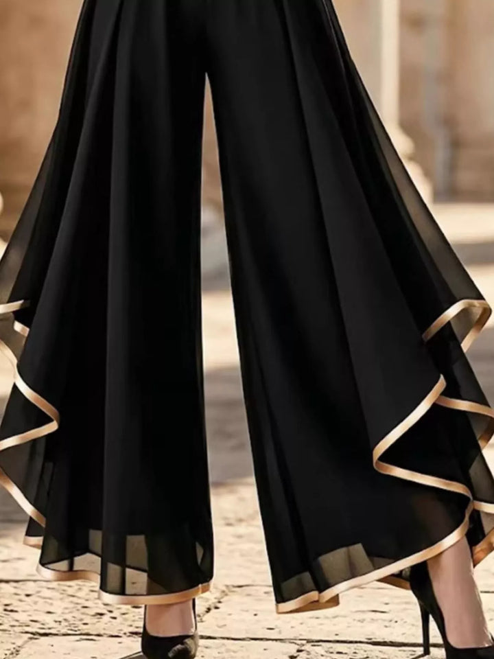 Close-up of the black sheer ruffle overlay with gold trimmed edge