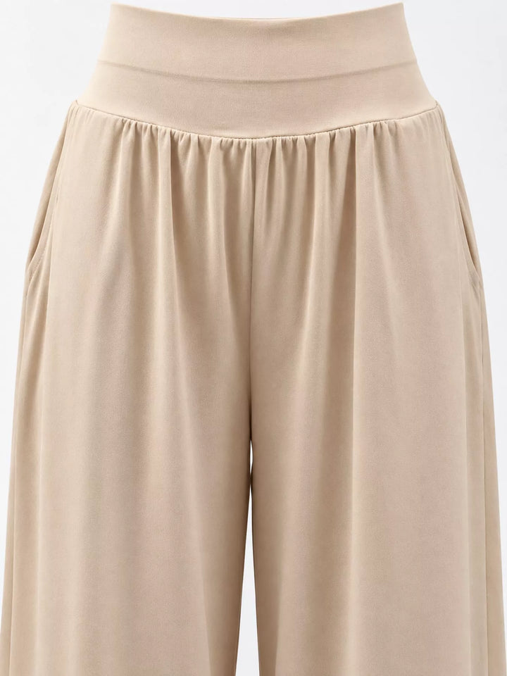 Beige high waisted wide leg pants, close-up of the waistband and soft gathers