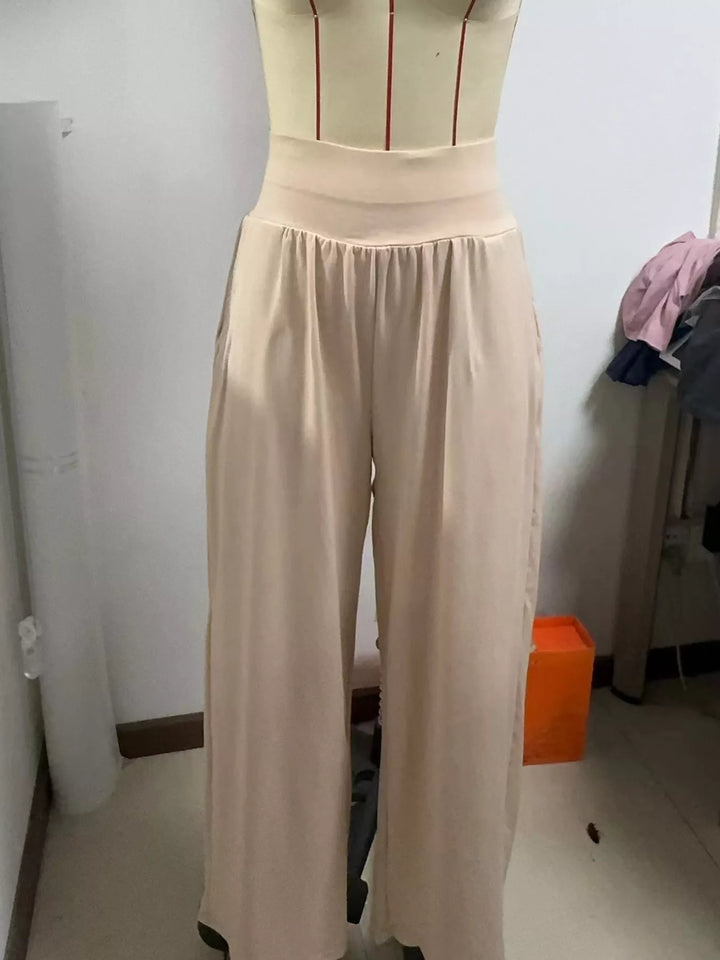 Beige high waisted wide leg pants, displayed on a form with the wide waistband