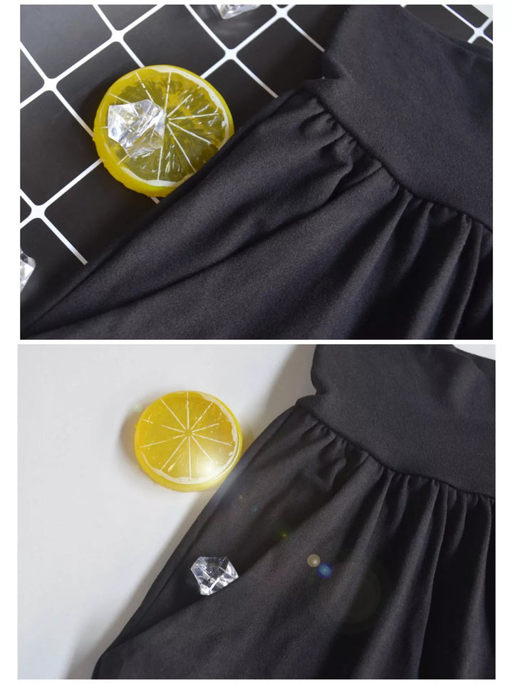 Black high waisted wide leg pants, waistband and pocket detail beside small lemon props
