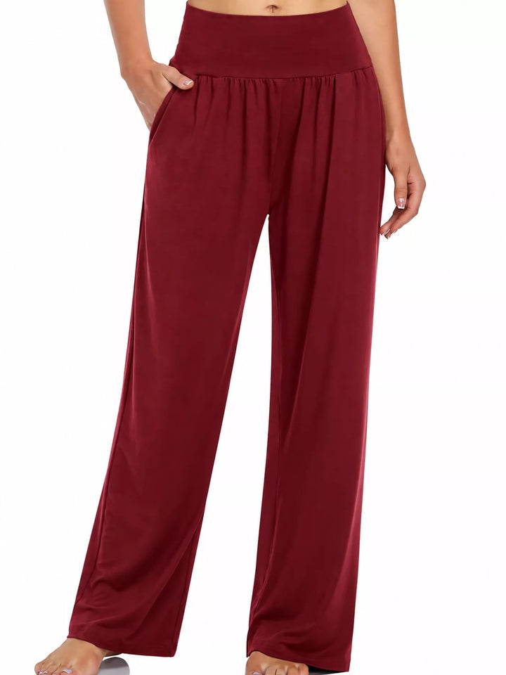 Burgundy high waisted wide leg pants, front view with hand in pocket