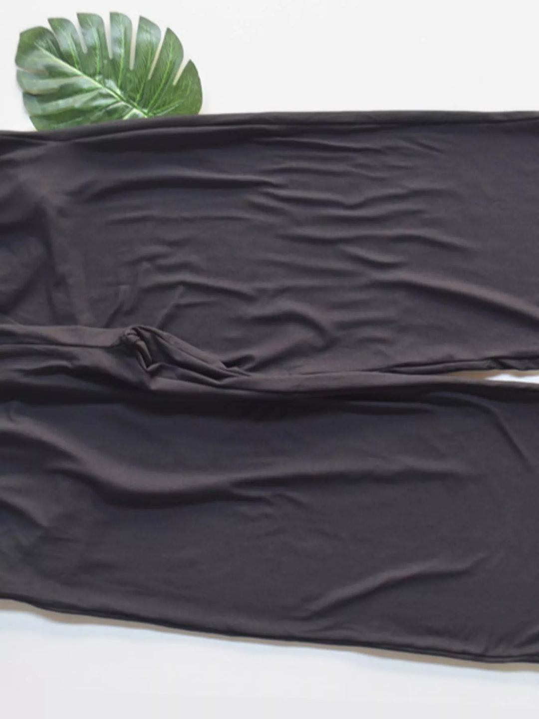 Charcoal high waisted wide leg pants, close-up of the soft draped fabric at the hem