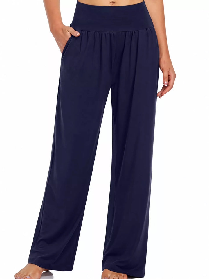 Navy high waisted wide leg pants, front view with hand in pocket