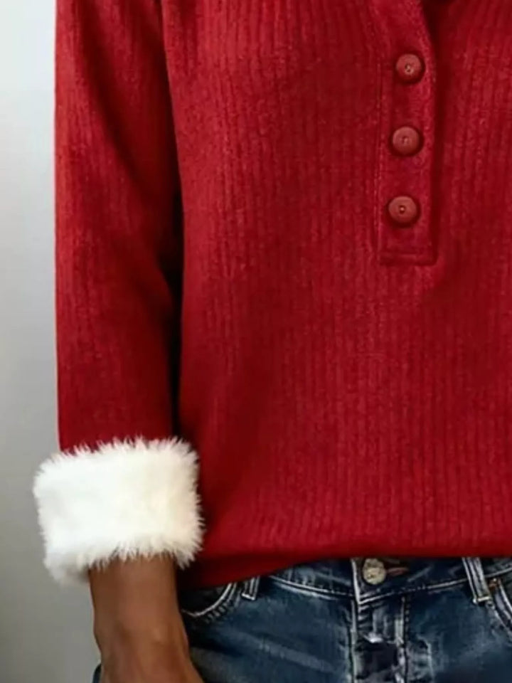Detail of the red ribbed sleeve with faux fur cuff and henley buttons