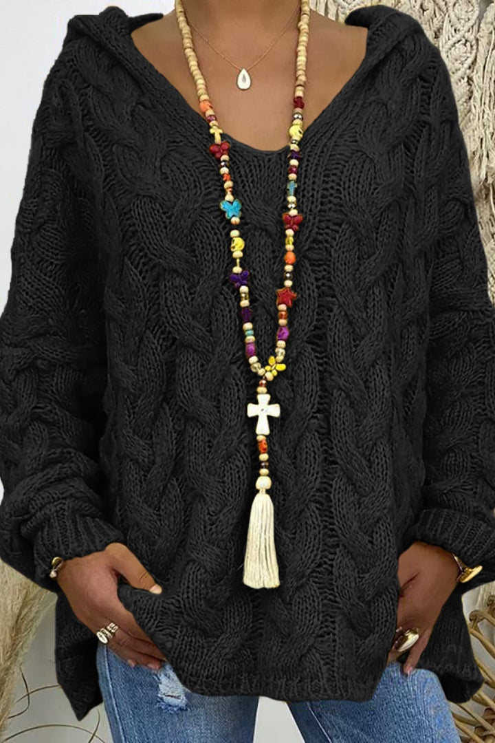 Close-up of the black cable knit hooded sweater with colorful beaded necklace