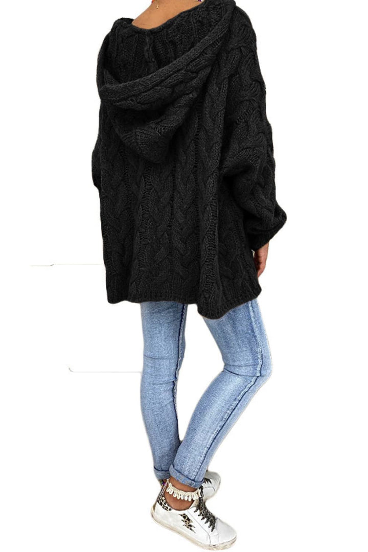 Black hooded sweater seen from the side, worn with light jeans and sneakers