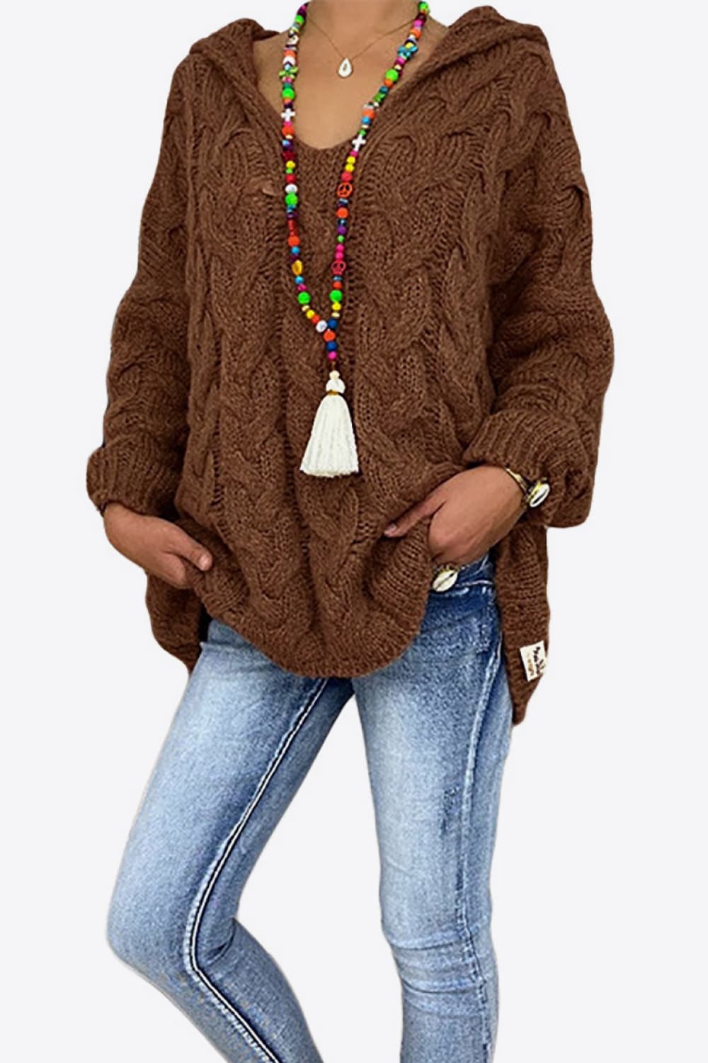 Brown oversized hooded sweater worn with light wash jeans, front view