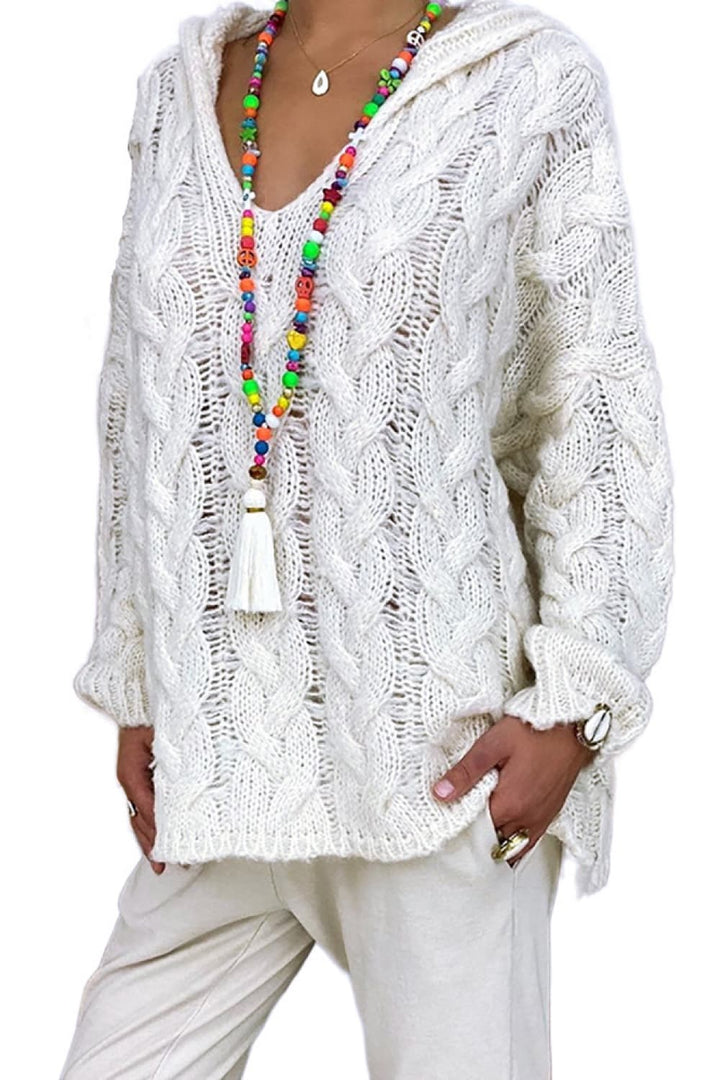 Ivory oversized cable knit hooded sweater with V neck, styled with white pants