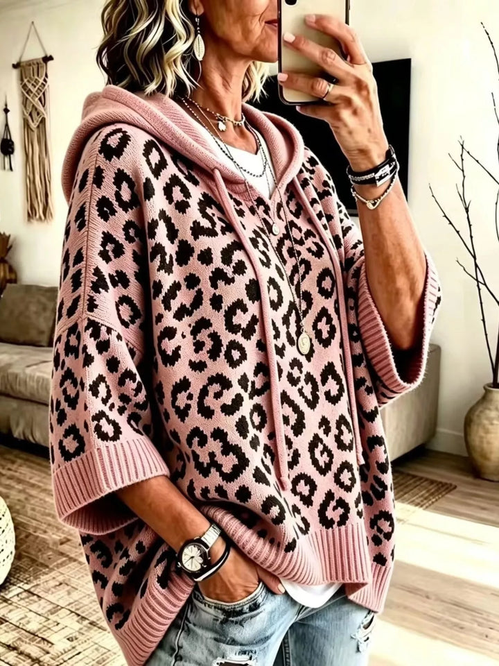 Rose pink hooded sweater with an oversized leopard jacquard pattern, front view