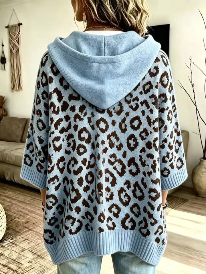 Back view of the sky blue oversized hooded sweater with a leopard pattern
