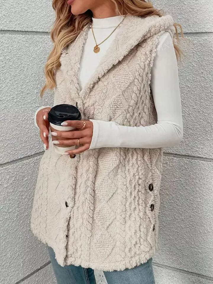 Cream longline hooded vest holding a coffee cup, front view