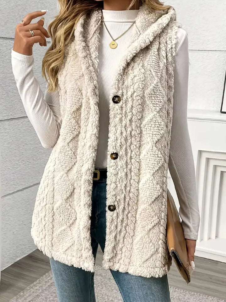 Cream button up vest with a hand in the pocket, side angle