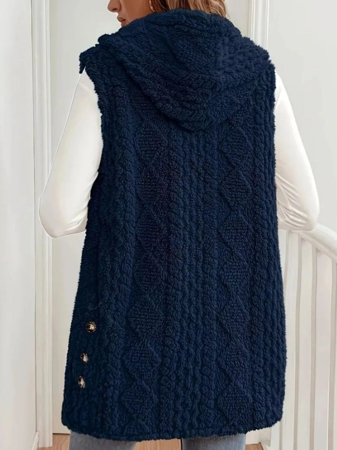 Back view of the navy cable knit vest with the hood