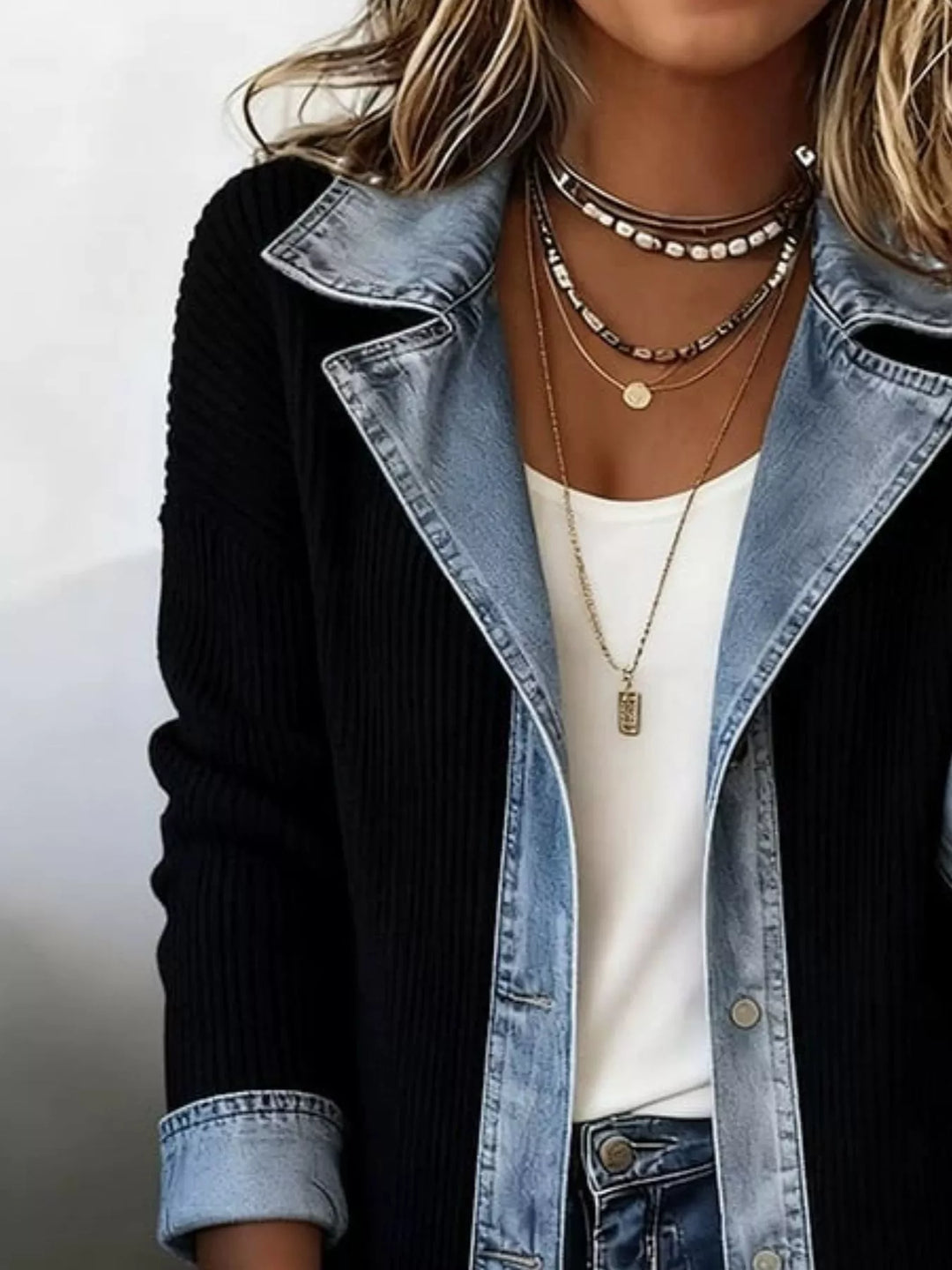 Close-up of the black ribbed knit jacket with denim lapel