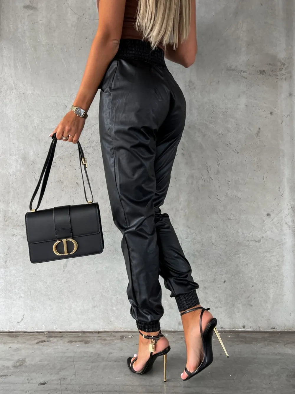 Back view of black jogger pants with a high smocked waist