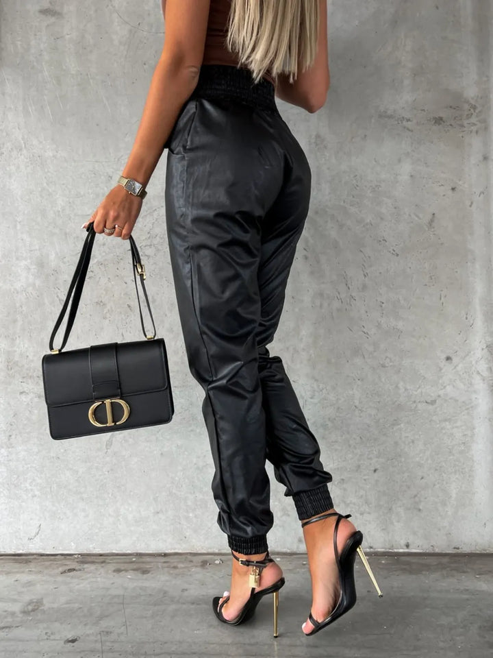 Back view of black jogger pants with a high smocked waist