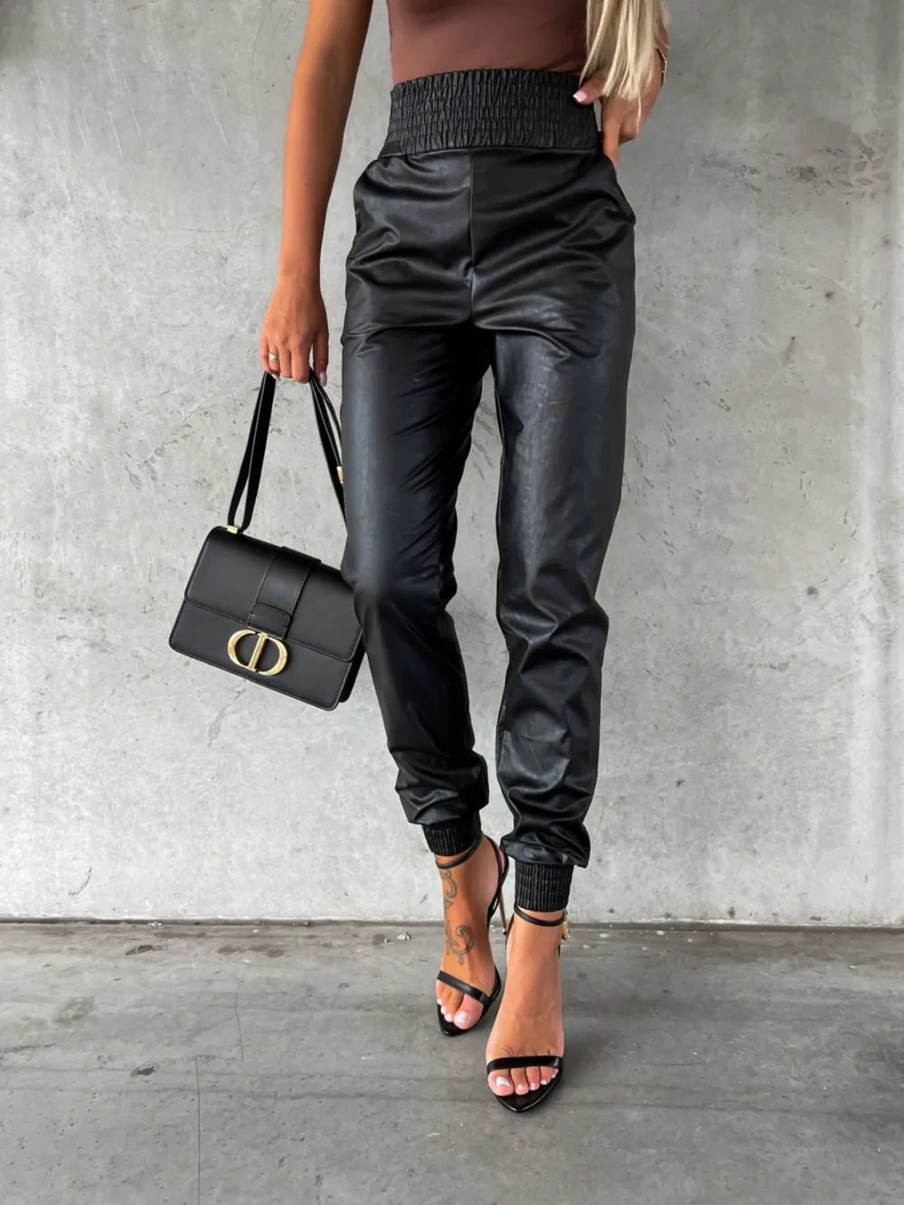 Black tapered leg jogger pants with smocked waist, close front view