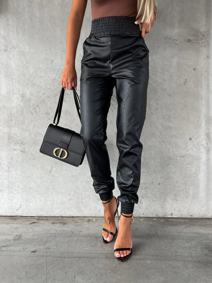 Black tapered leg jogger pants with smocked waist, close front view