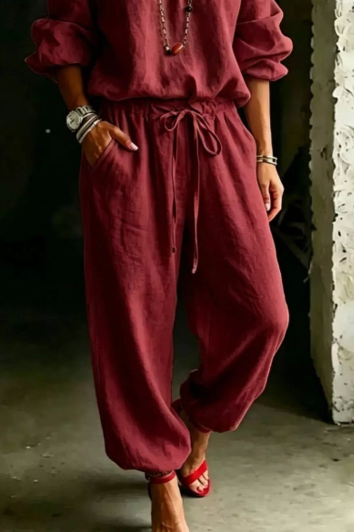 Burgundy jogger pants with tie waist and top, angled lower body view
