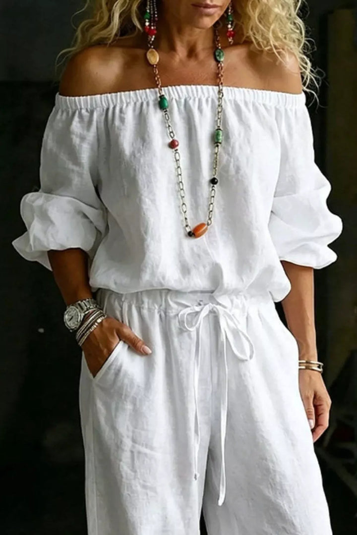 White off shoulder puff sleeve top and drawstring pants, closer front view
