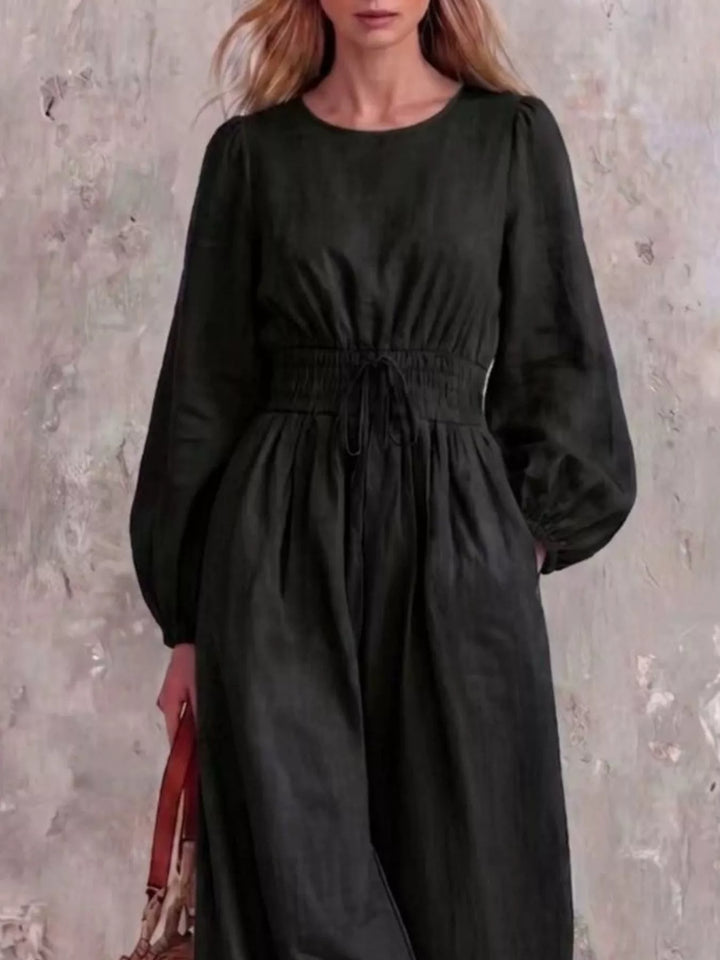 Black jumpsuit with cinched waist and round neckline, closer front view
