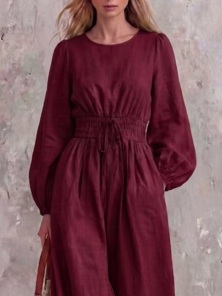 Burgundy jumpsuit with cinched waist and round neckline, closer front view