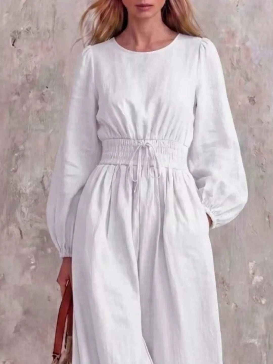 White jumpsuit with cinched waist and round neckline, closer front view