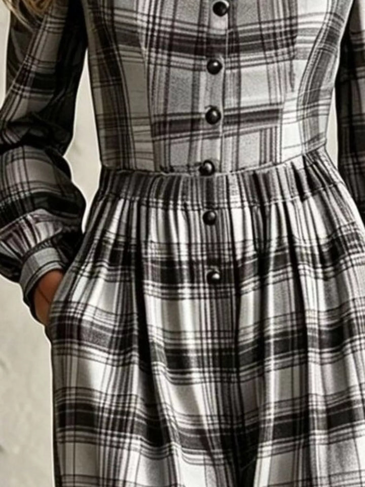 Close-up of black and white plaid jumpsuit buttons and pleated waist