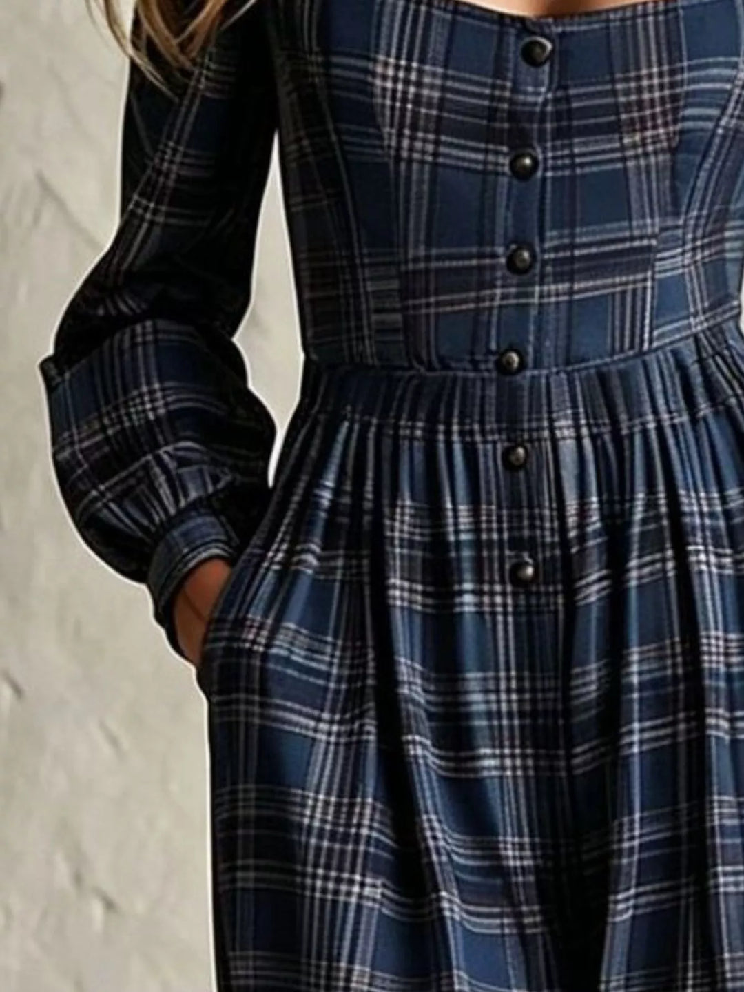 Close-up of navy plaid jumpsuit button front and pocket detail