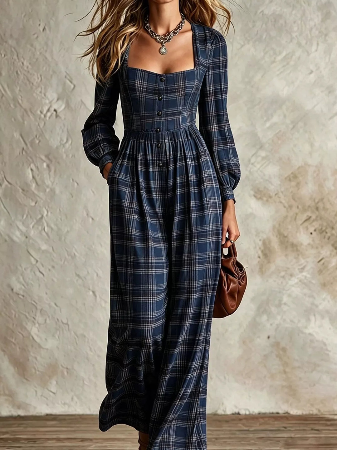 navy plaid jumpsuit with long sleeves and wide legs, styled with a small bag