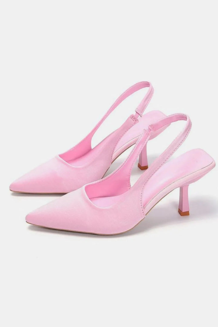 Light pink slingback kitten heels with a pointed toe, pair side view