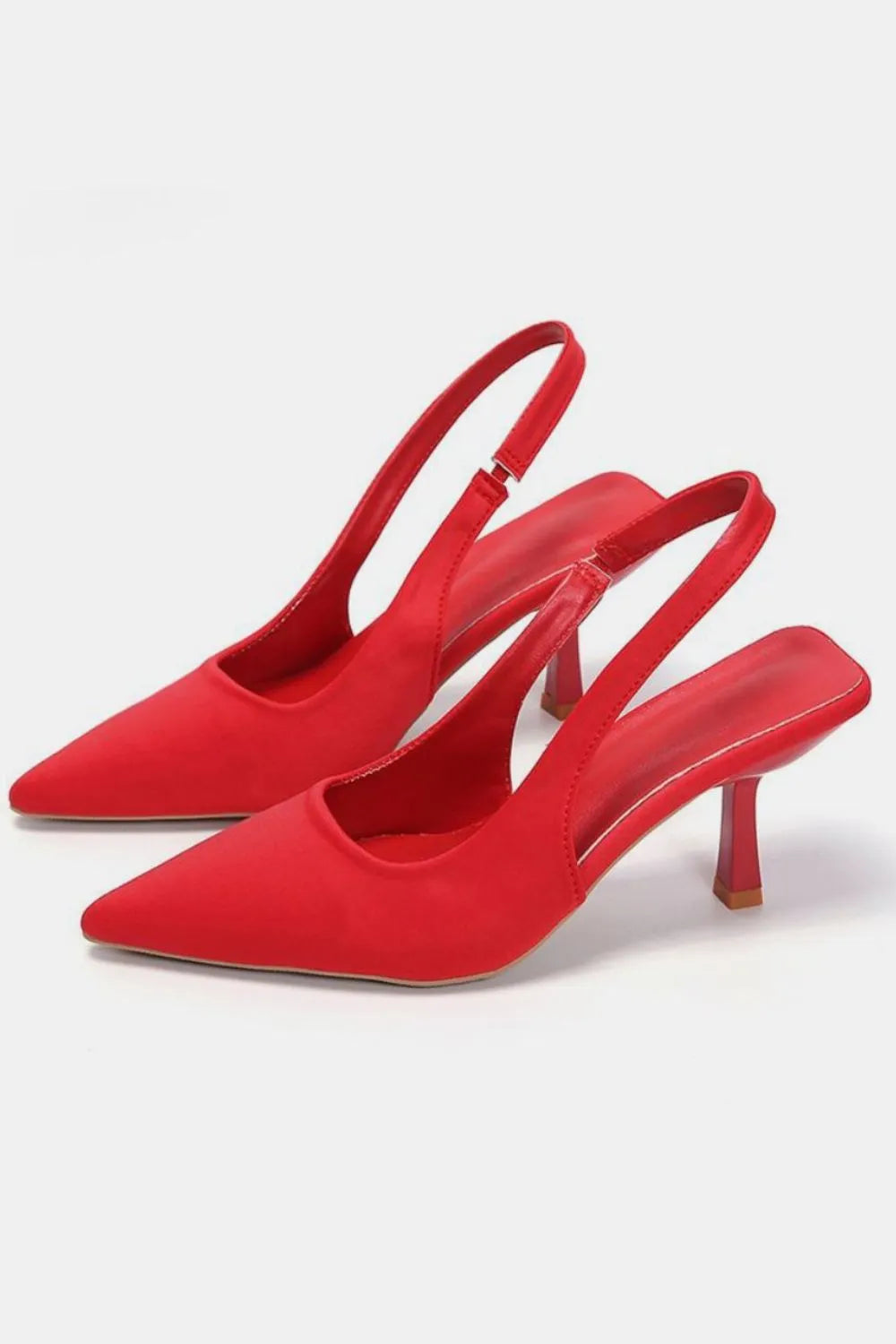 Red pointed toe slingback kitten heel pumps shown as a pair