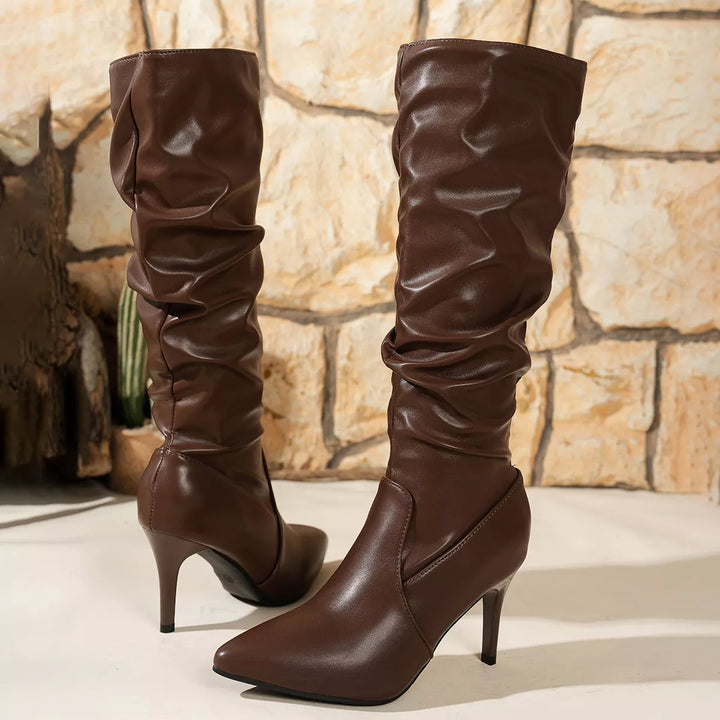 Back view of brown slouchy knee high boots with stiletto heels