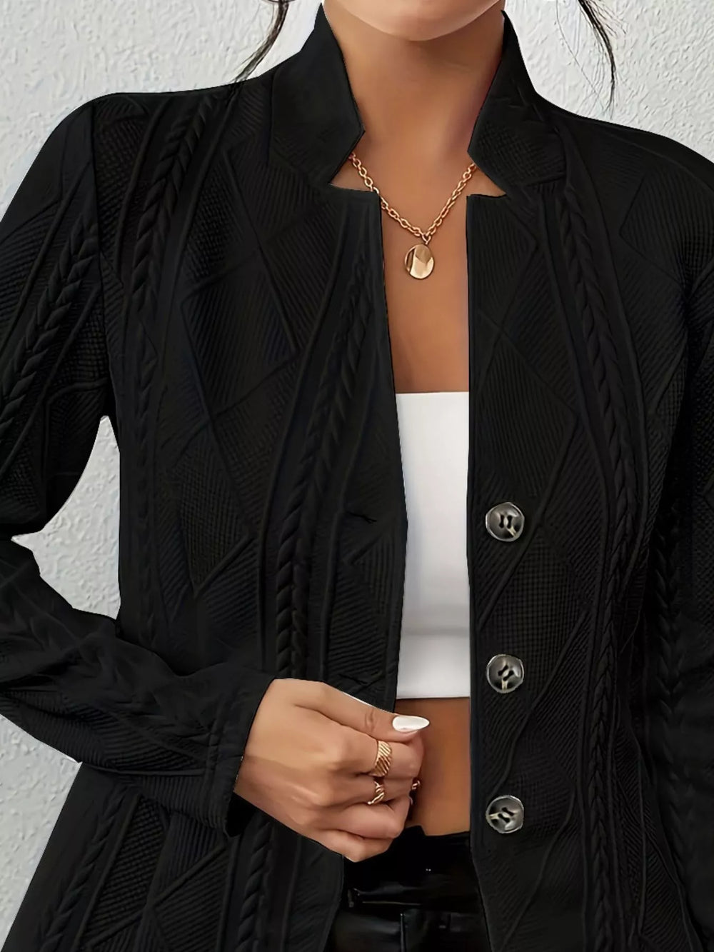 Close-up of the black blazer stand collar and textured knit