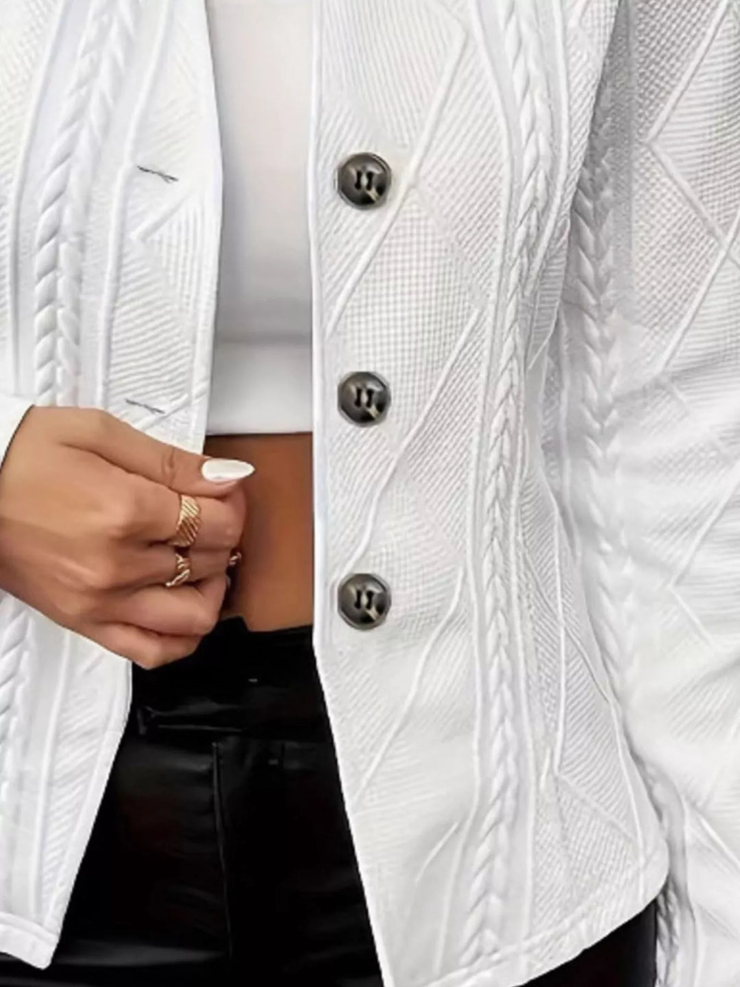Close-up of the white blazer buttons and cable texture