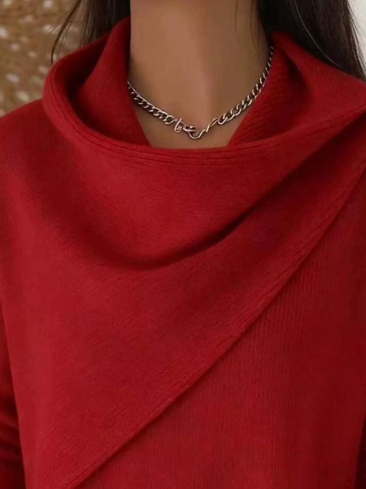 Draped diagonal cowl neck ribbed hem in red, close-up detail