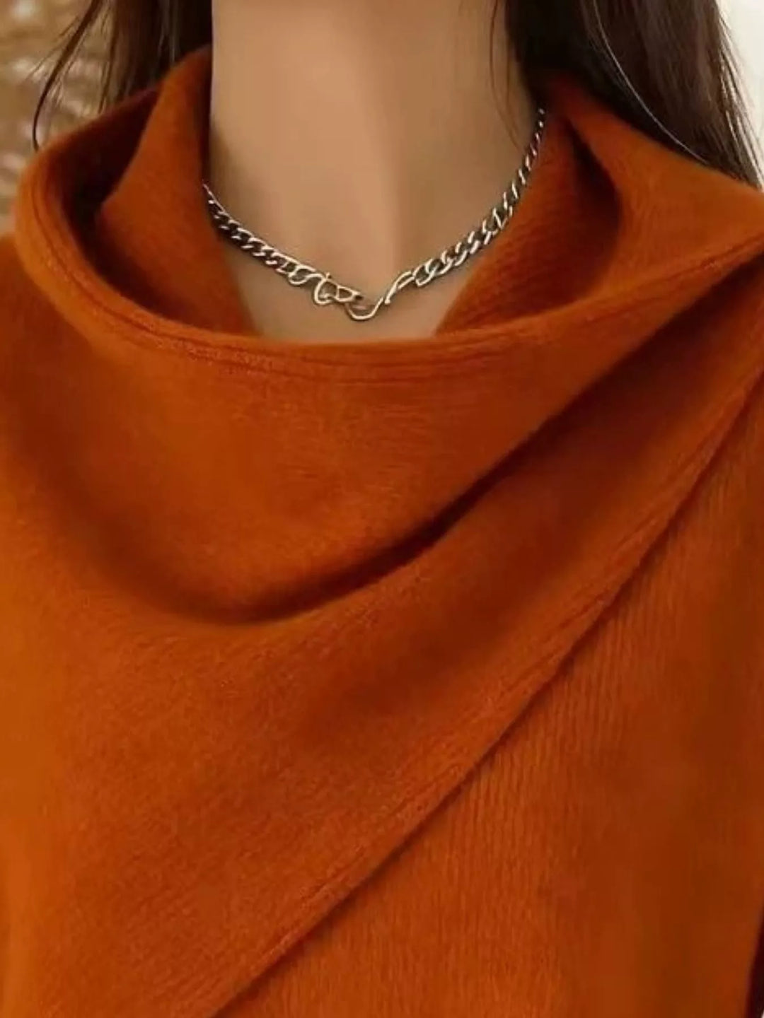Draped diagonal cowl neck ribbed hem in tan, close-up detail